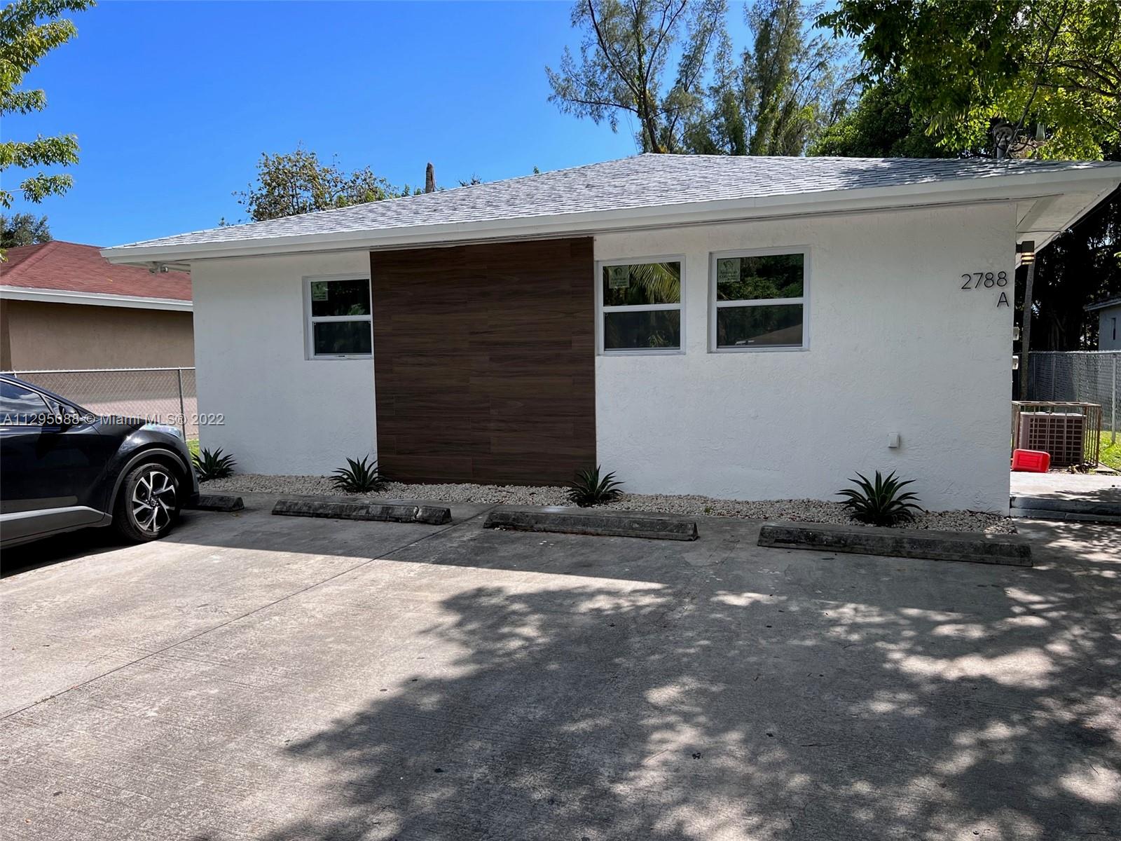 Brownsville Miami, FL 33142 - Photo 1 of 33 a front view of a house with a yard
