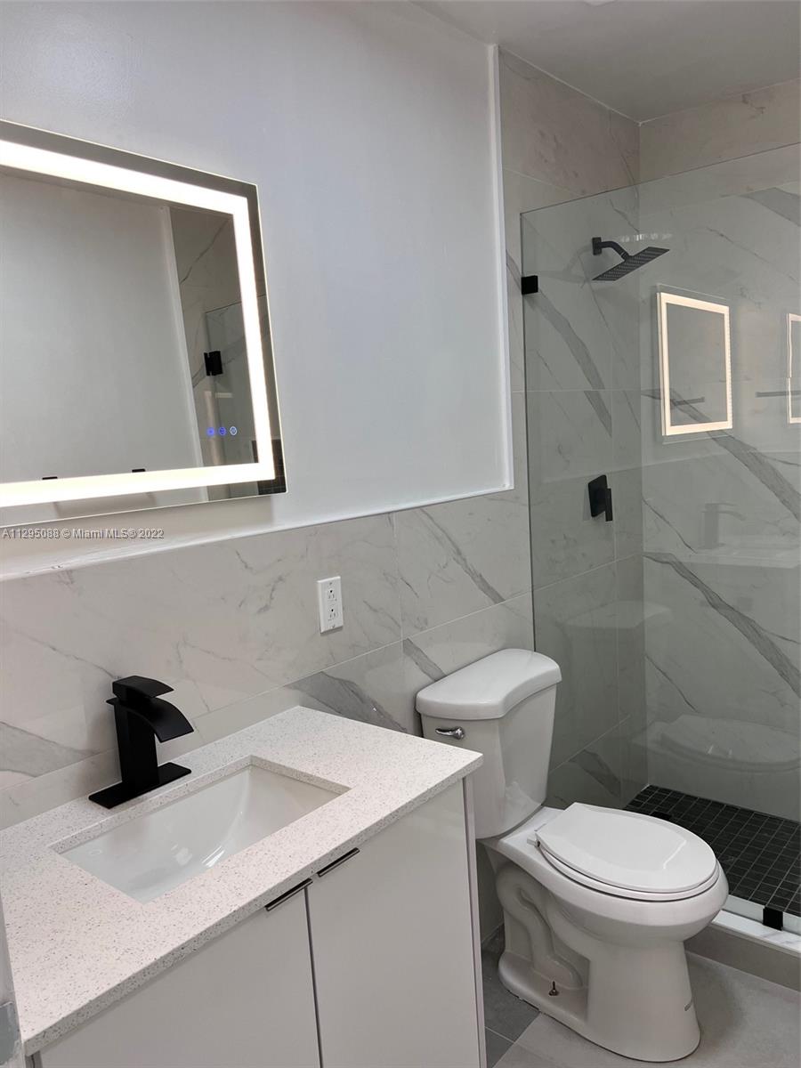 Brownsville Miami, FL 33142 - Photo 12 of 33 a bathroom with a sink a toilet and shower