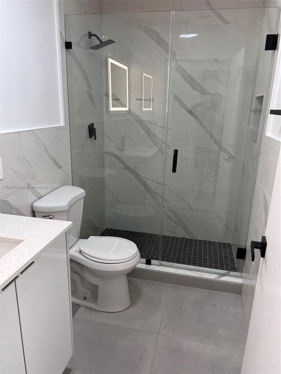 Brownsville Miami, FL 33142 - Photo 13 of 33 a bathroom with a toilet and a shower