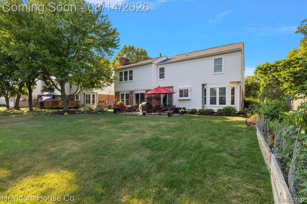 45697 Bryn Mawr Road Canton, MI 48187 - Photo 26 of 75 Expansive rear yard featuring a manicured lawn, established landscaping, and mature trees