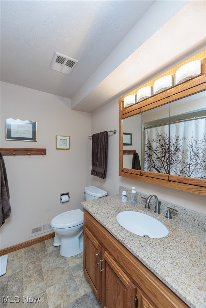 37451 Hunters Ridge Solon, OH 44139 - Photo 18 of 42 Full bathroom with vanity and stone finish floors