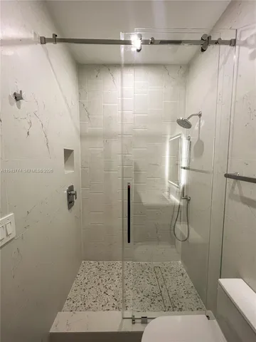 a bathroom with a bathtub toilet and shower