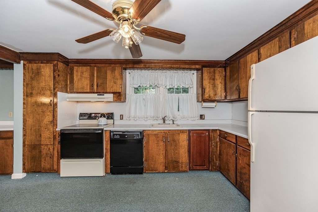 60 Rangeway Road Billerica, MA 01862 - Photo 6 of 36 a kitchen with stainless steel appliances granite countertop a sink a stove a refrigerator cabinets and a dining table