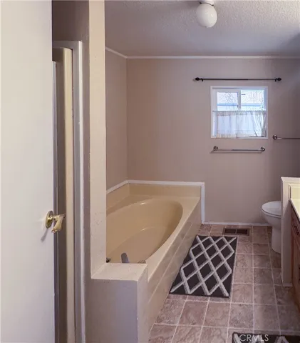 a bathroom with a bathtub and a toilet