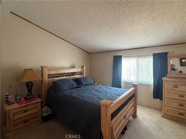 a bed sitting in a bedroom next to a window