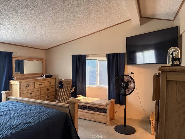 a bedroom with furniture and a flat screen tv