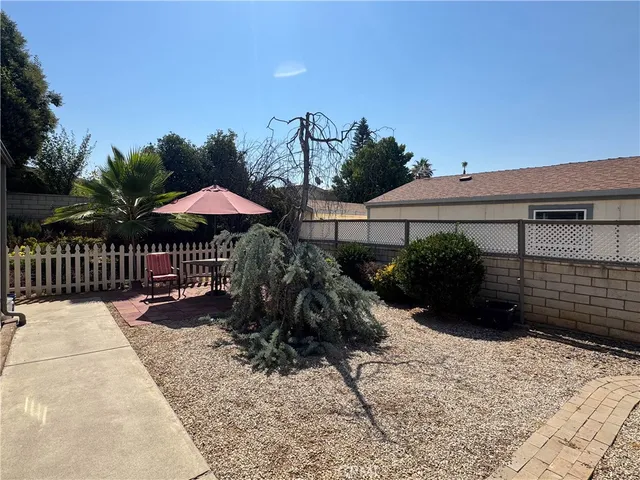 a view of a chairs and table under an umbrella in patio