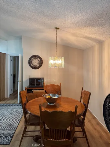 a view of a dining room with furniture and a chandelier