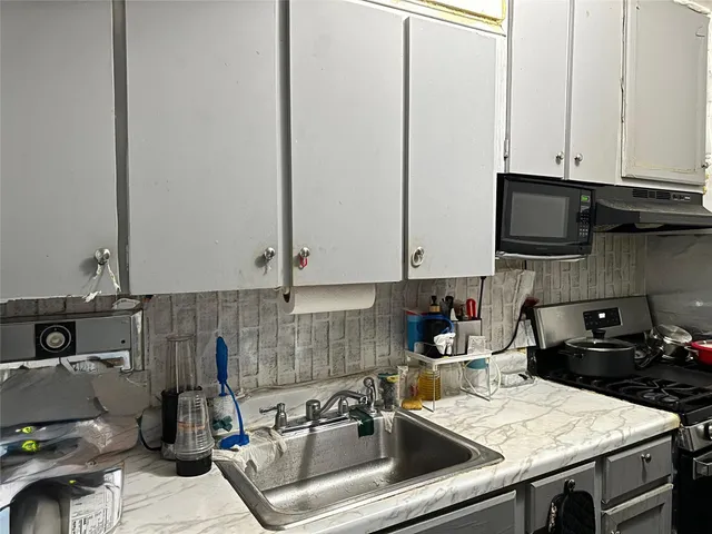 a kitchen with a sink and cabinets