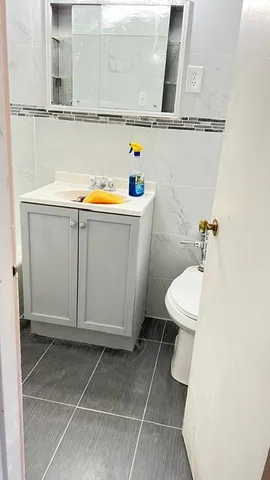 a bathroom with a toilet a sink and a window