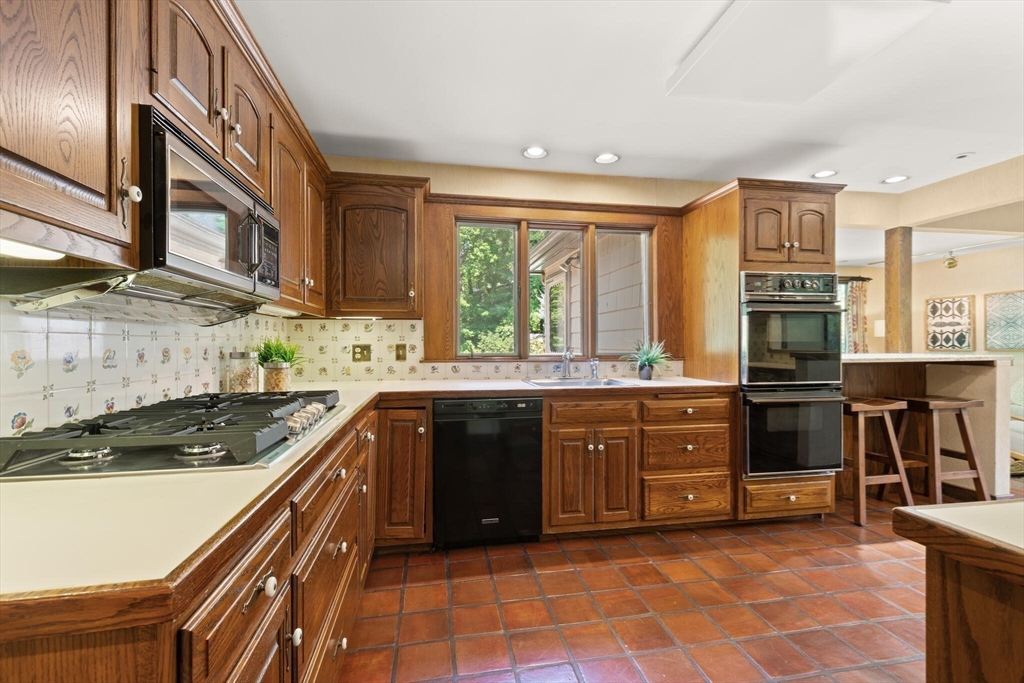 77 Wellesley Road Belmont, MA 02478 - Photo 13 of 31 a kitchen with stainless steel appliances granite countertop a stove and a sink