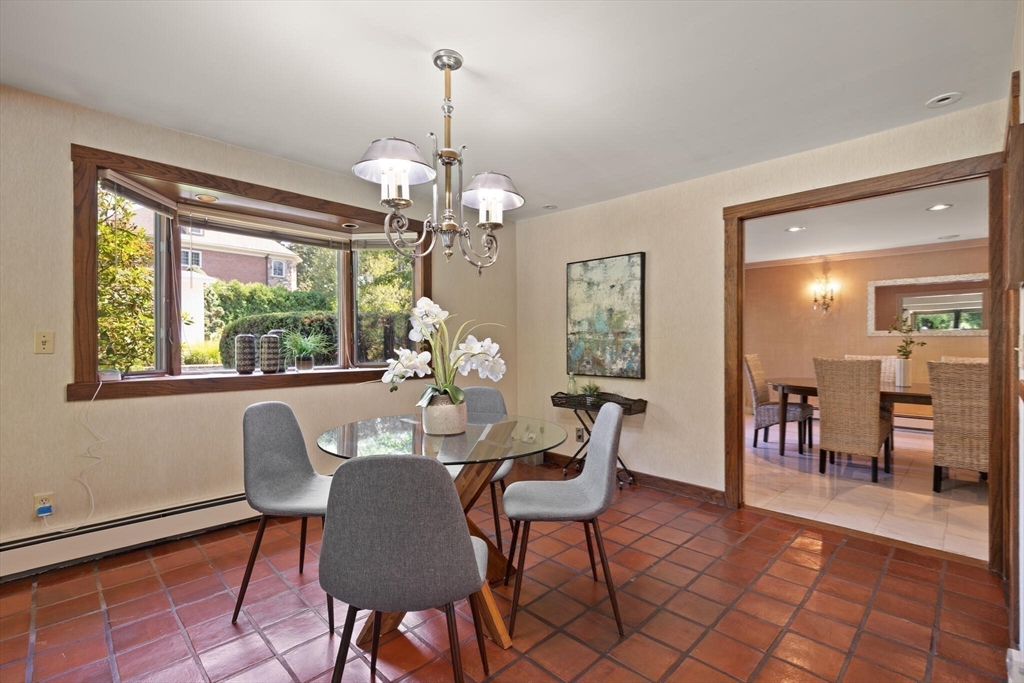 77 Wellesley Road Belmont, MA 02478 - Photo 16 of 31 a dining room with furniture a chandelier and wooden floor