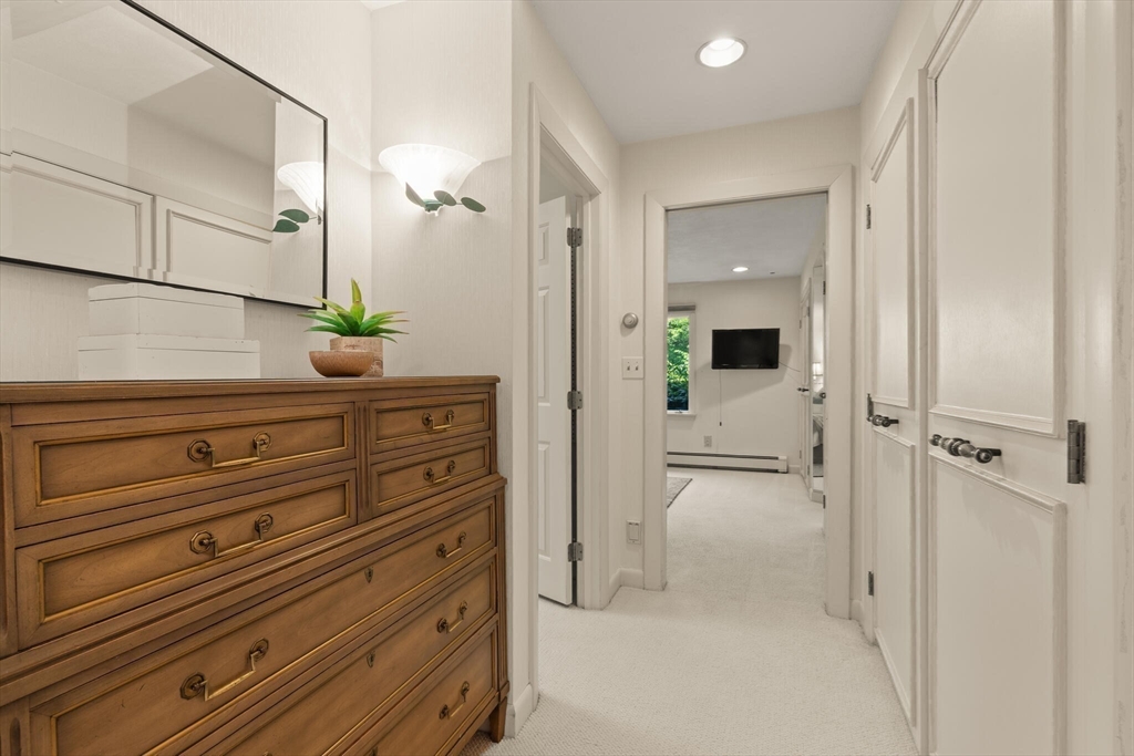 77 Wellesley Road Belmont, MA 02478 - Photo 19 of 31 a view of a hallway and closet with mirror