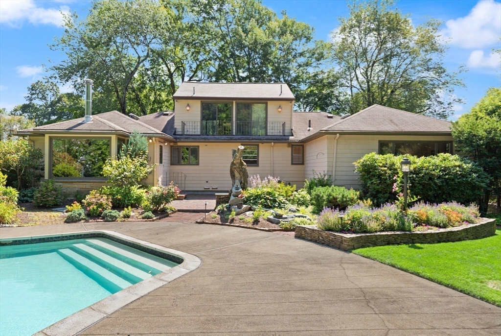 77 Wellesley Road Belmont, MA 02478 - Photo 2 of 31 a front view of a house with a yard and potted plants