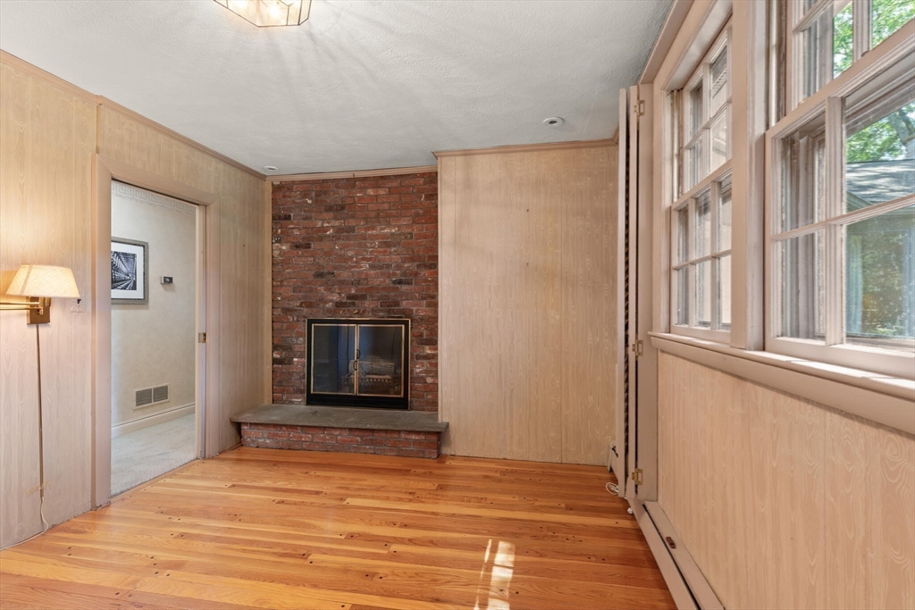 77 Wellesley Road Belmont, MA 02478 - Photo 23 of 31 a view of an empty room with a fireplace and a window