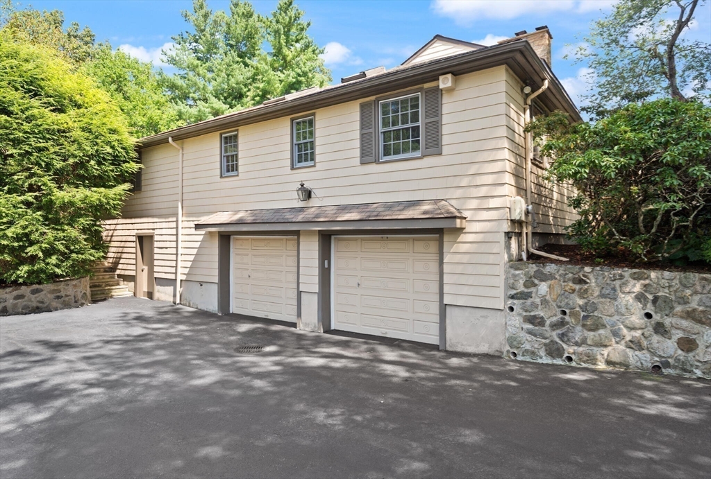 77 Wellesley Road Belmont, MA 02478 - Photo 28 of 31 a front view of a house with a garage