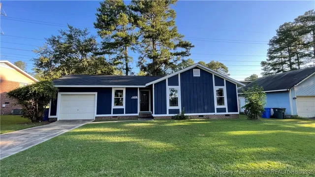 a front view of house with yard and green space
