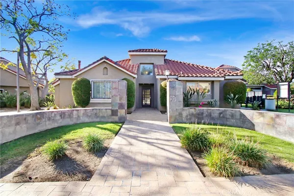 a view of a house with a swimming pool and a chairs in a patio