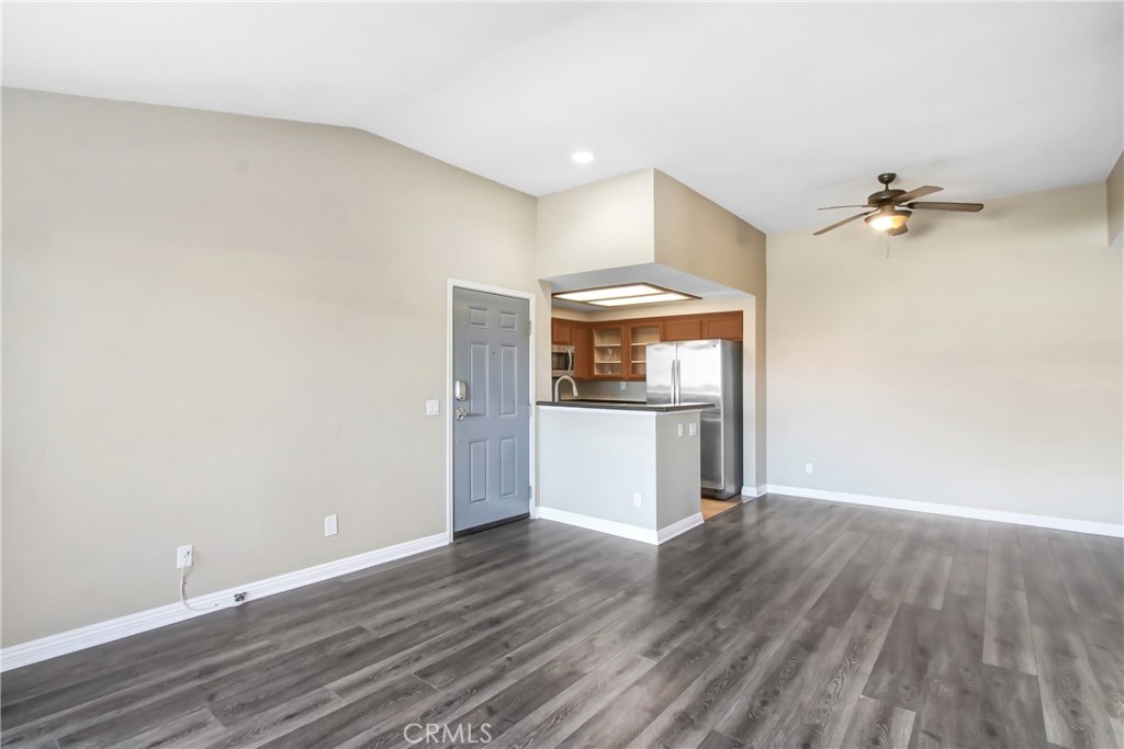 200 East Alessandro Boulevard, Unit 106 Riverside, CA 92508 - Photo 3 of 16 a view of a kitchen with a fridge and wooden floor