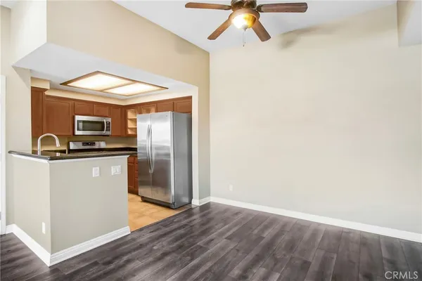a kitchen with stainless steel appliances a refrigerator and a stove top oven