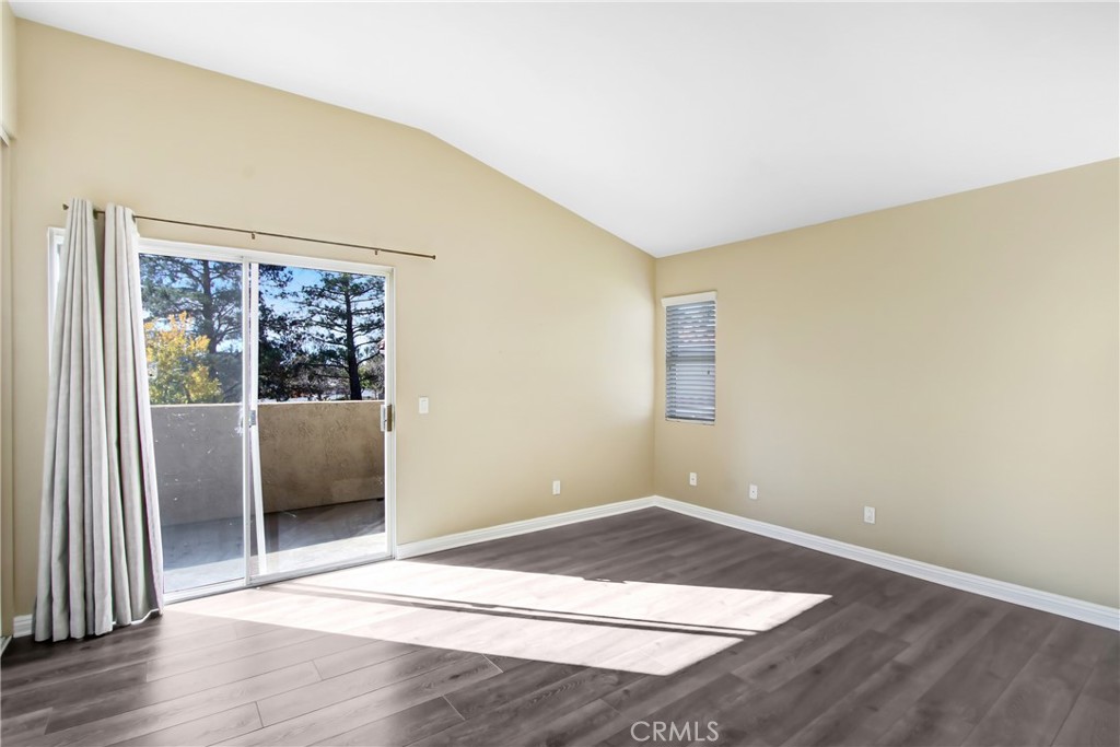 200 East Alessandro Boulevard, Unit 106 Riverside, CA 92508 - Photo 9 of 16 a view of an empty room with wooden floor and a window