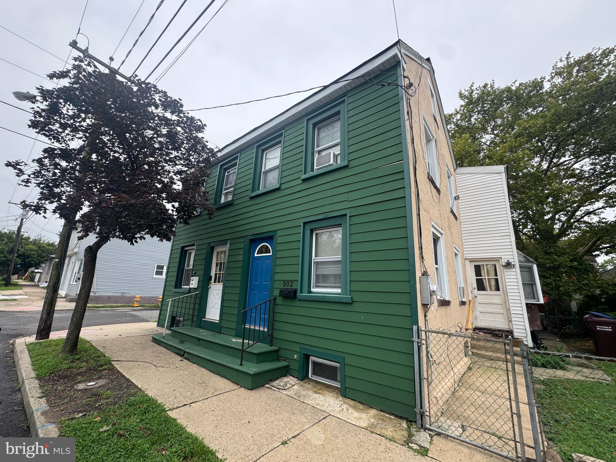 300-302 Madison Street Riverside, NJ 08075 - Photo 2 of 3 a front view of a house with garden