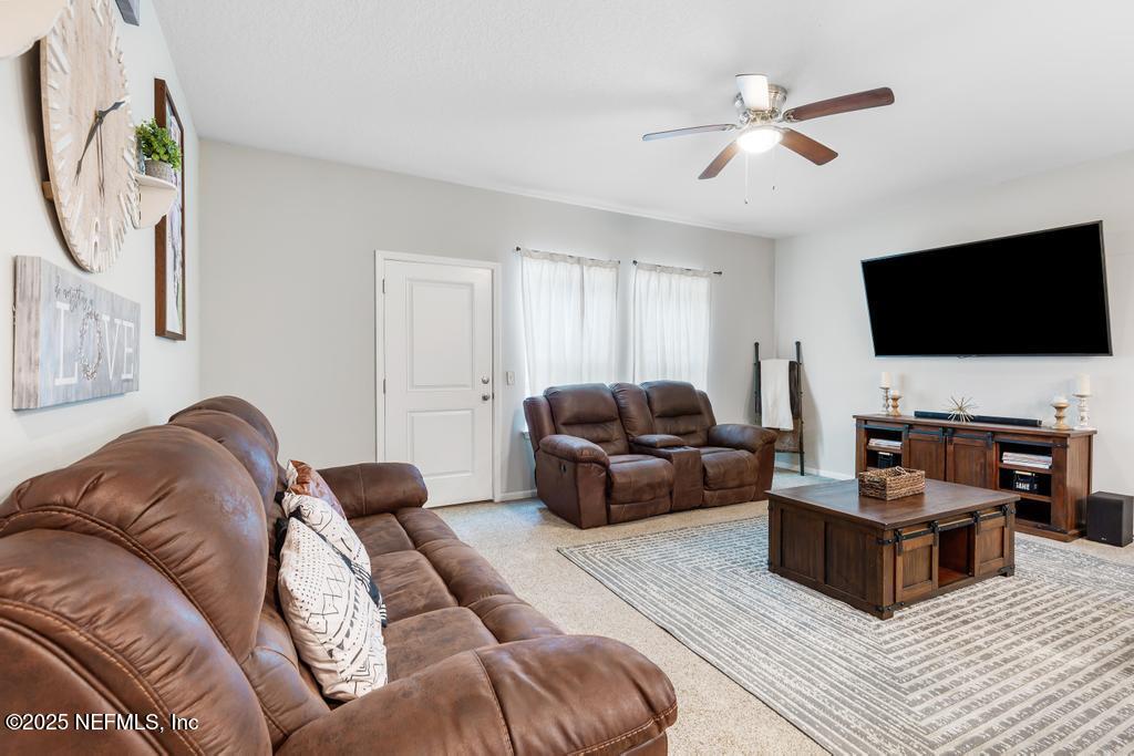 87267 Lents Road Yulee, FL 32097 - Photo 10 of 28 a living room with furniture and a flat screen tv