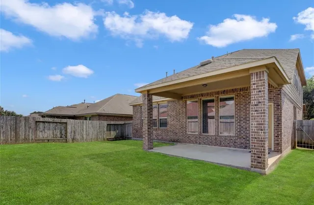 a view of a house with a backyard