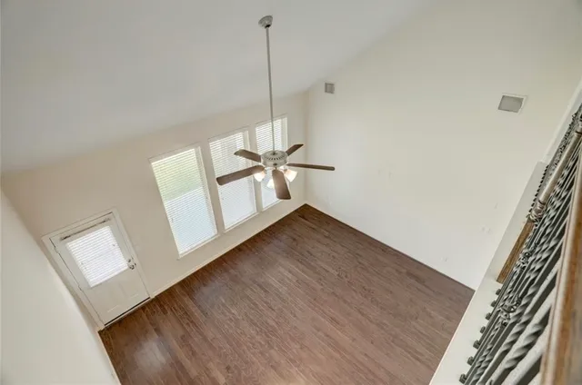 a view of a room with wooden floor and white walls