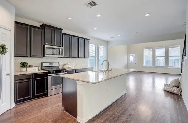 a kitchen with stainless steel appliances granite countertop a sink stove and oven