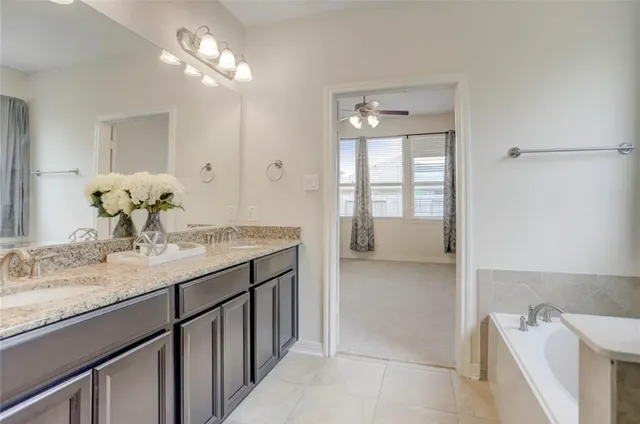 a bathroom with a granite countertop sink a large mirror and shower