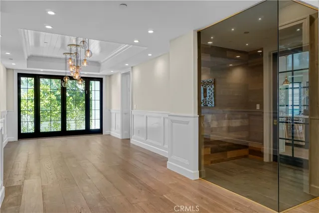 a view of entryway and hall with wooden floor