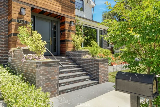a view of a house with potted plants