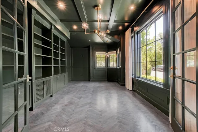 a bathroom with a granite countertop sink a toilet a mirror and a glass door shower