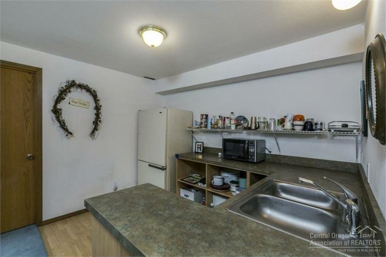 21645 Northeast Butler Market Road Bend, OR 97701 - Photo 6 of 13 a view of a hallway to room with workspace and windows