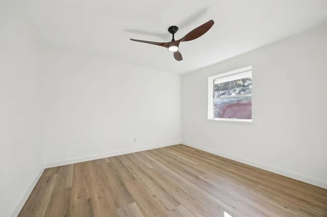 a view of a room with wooden floor
