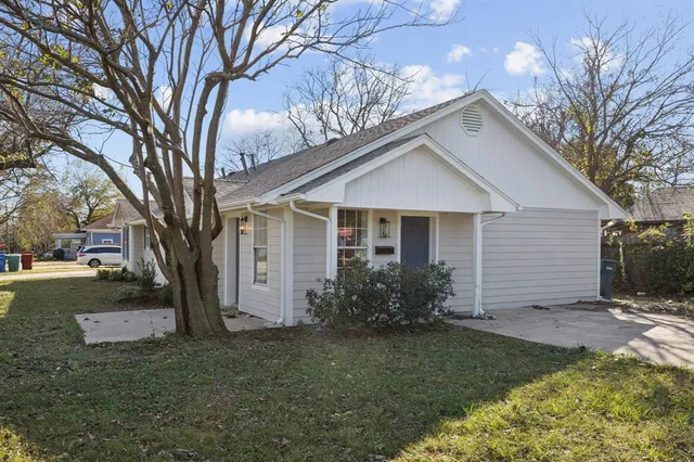 a view of a house with yard and a garden