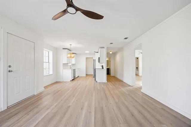 a view of empty room with wooden floor