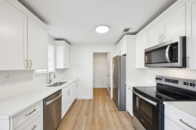 a kitchen with a sink microwave and refrigerator