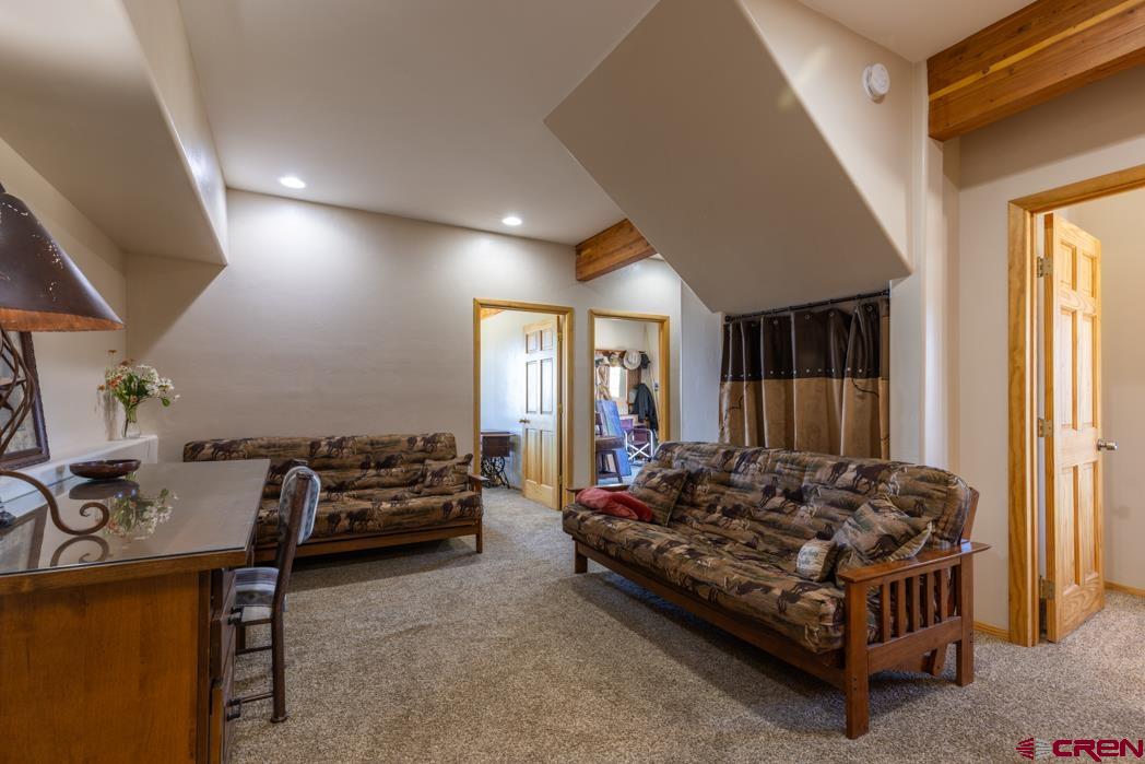 1737 Roberts Ridge Drive Hesperus, CO 81326 - Photo 21 of 34 a large bed sitting in a room next to a window