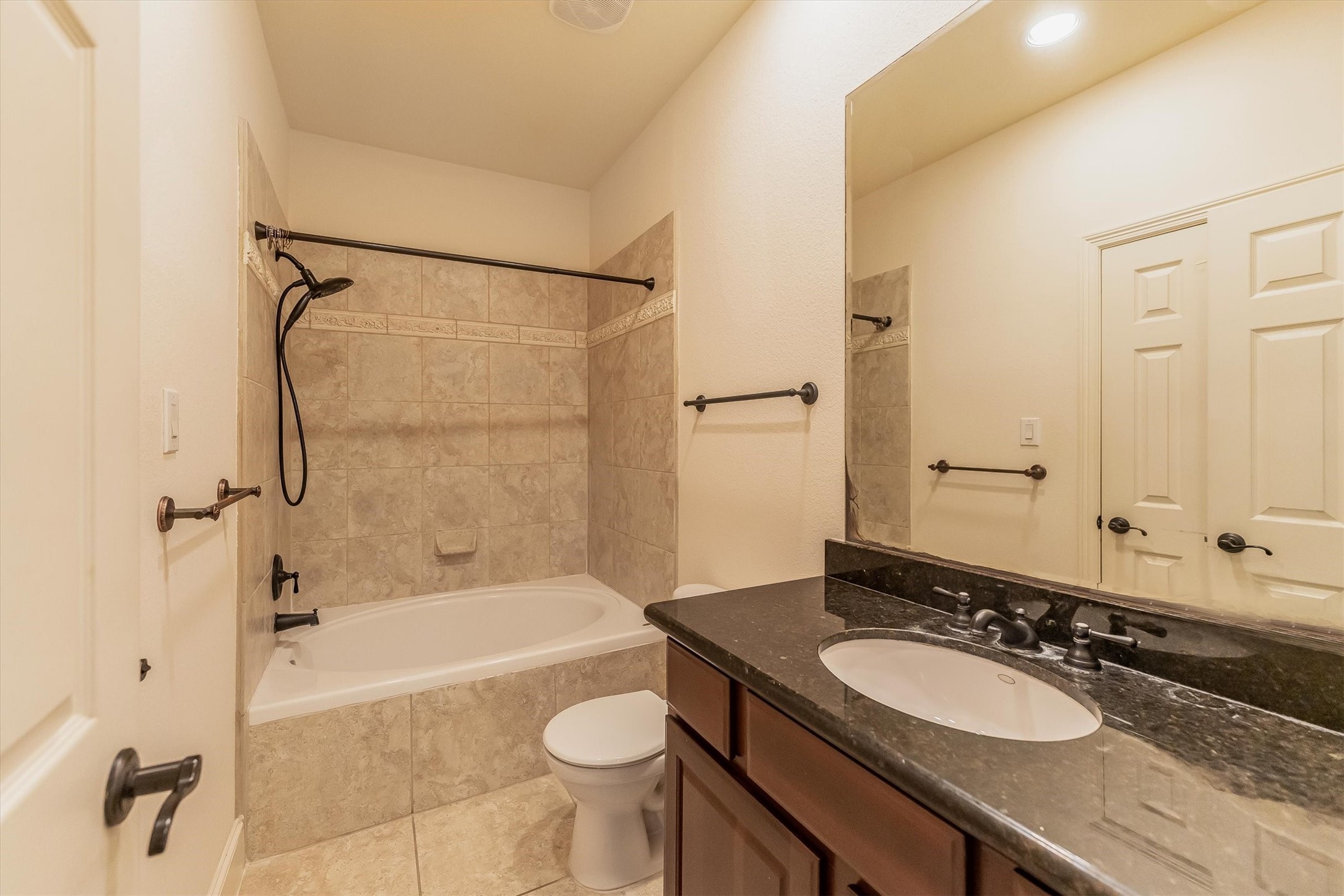308 Grove Street Houston, TX 77020 - Photo 25 of 28 a bathroom with a granite countertop sink toilet mirror and bathtub