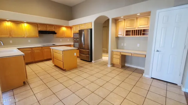 a kitchen with stainless steel appliances granite countertop a refrigerator and a stove