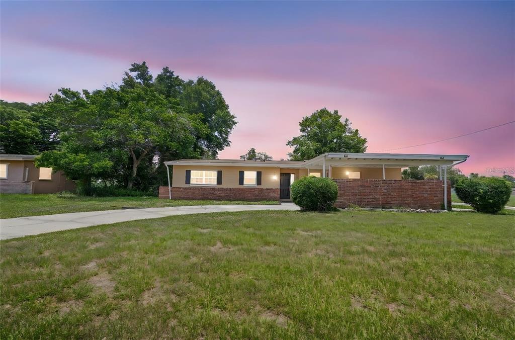 5825 Forest Grove Boulevard Orlando, FL 32808 - Photo 1 of 19 a front view of a house with a yard