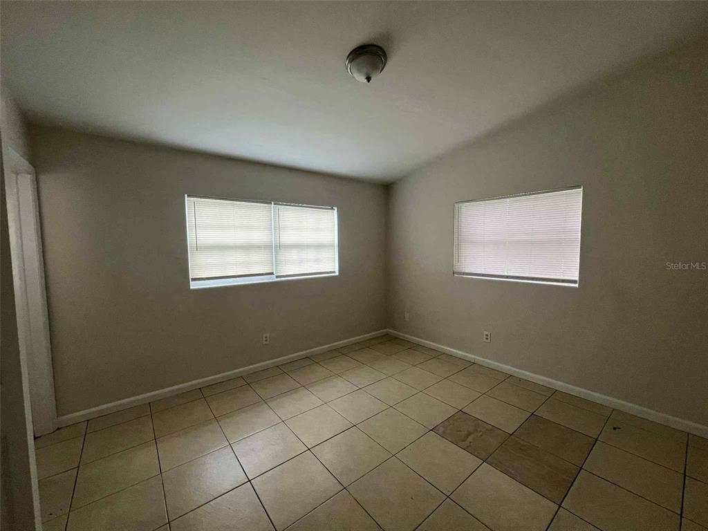 5825 Forest Grove Boulevard Orlando, FL 32808 - Photo 6 of 19 a view of an empty room with a window