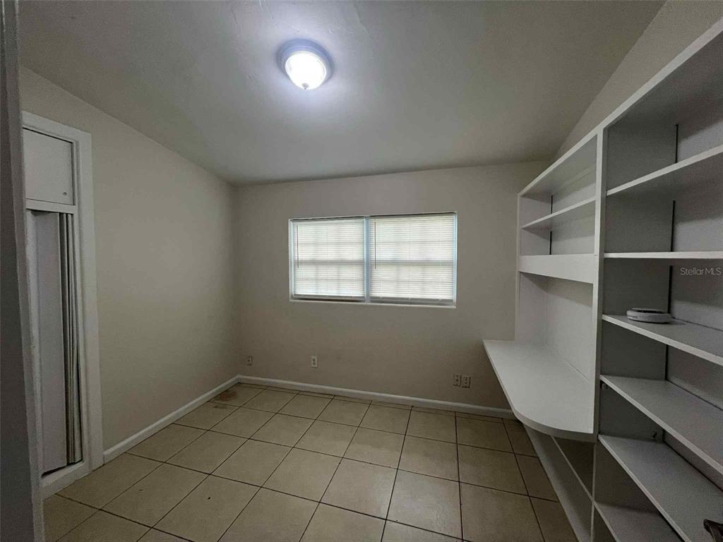 5825 Forest Grove Boulevard Orlando, FL 32808 - Photo 7 of 19 a view of an empty room with a window