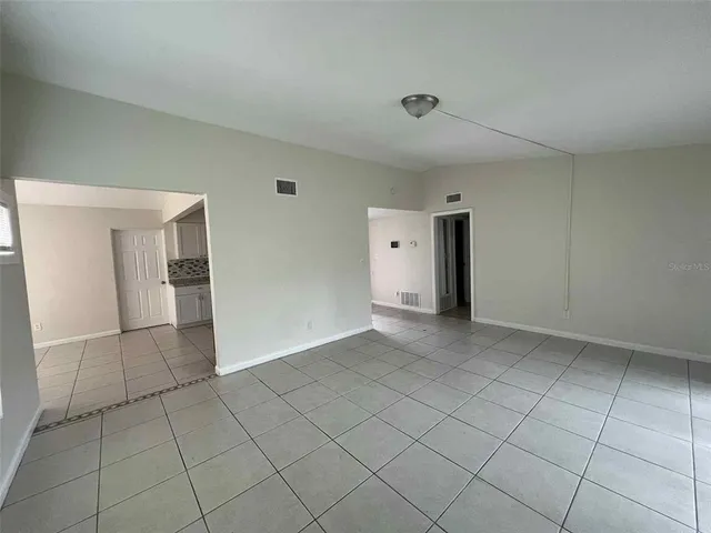 a view of an empty room with closet