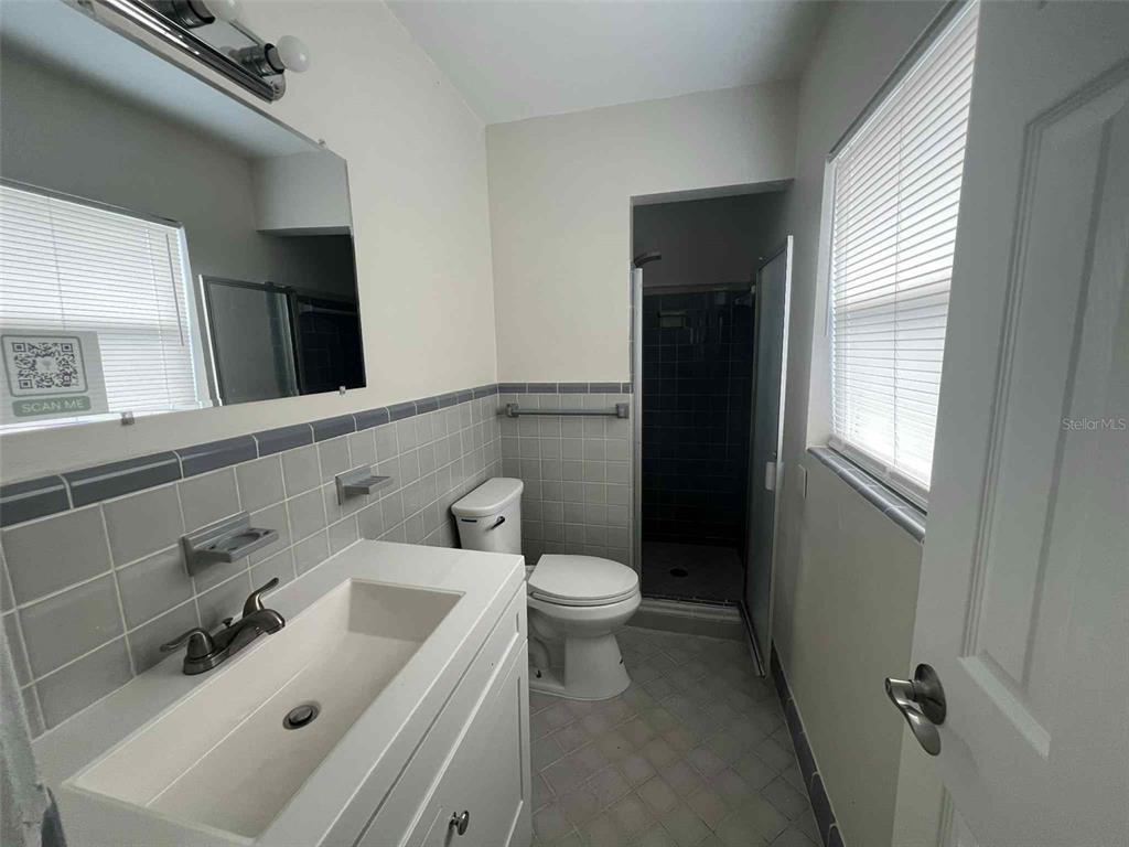 5825 Forest Grove Boulevard Orlando, FL 32808 - Photo 10 of 19 a bathroom with a sink a toilet and shower