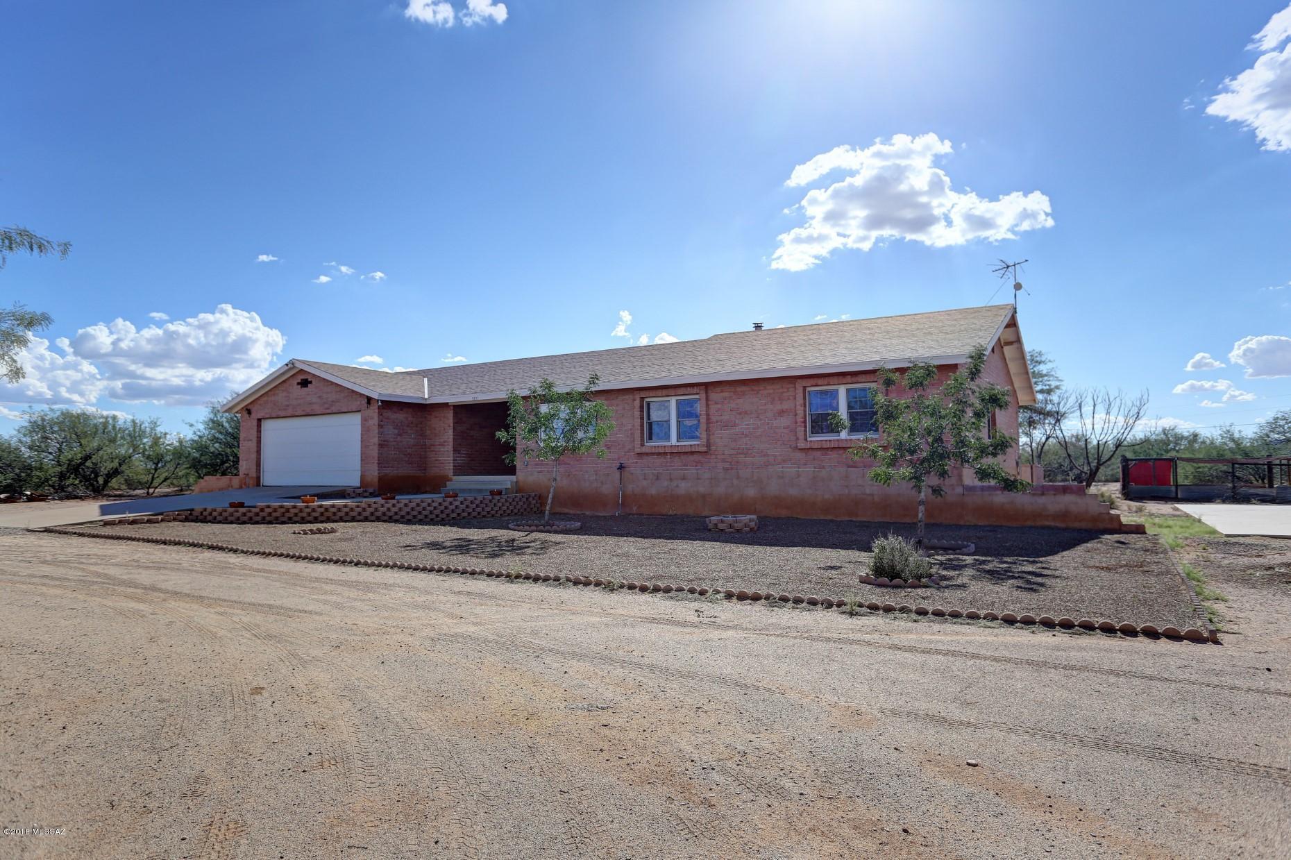 5851 South Avra Road Tucson, AZ 85735 - Photo 45 of 46 a view of a house with a yard and garage
