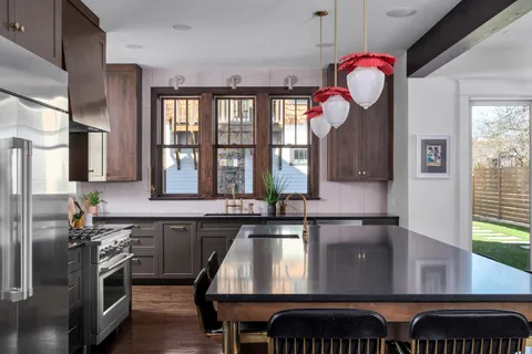 a view of a livingroom with furniture fireplace and a window