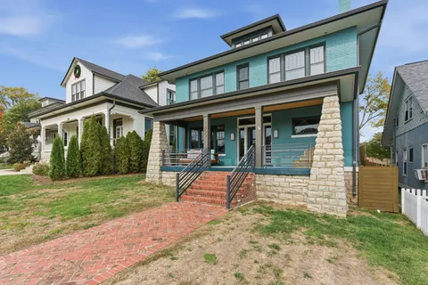 a kitchen with stainless steel appliances granite countertop a stove a kitchen island a dining table and chairs